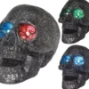 Teschio con luce negli occhi in colori assortiti 14 cm